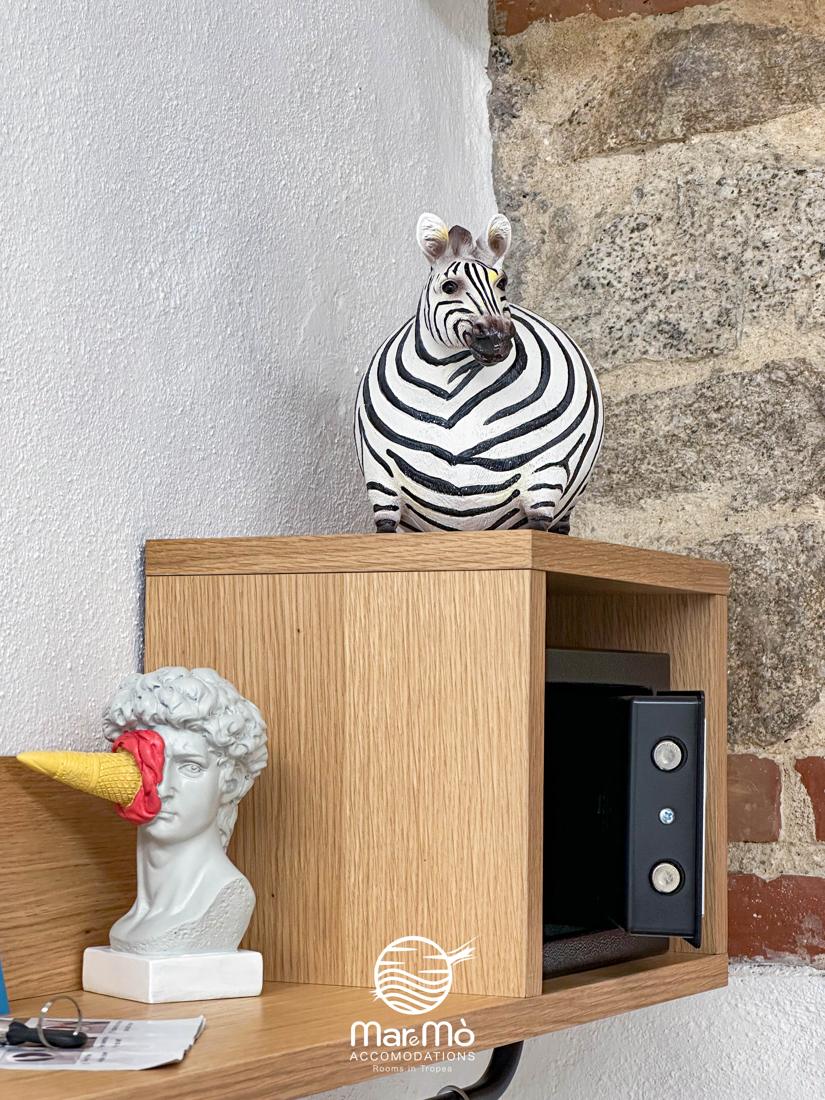 Comodino in legno con cassaforte e statuetta zebra